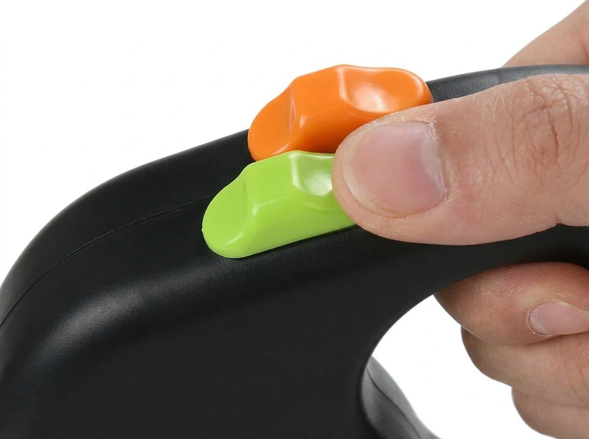 A thumb on the lime and orange lock buttons on top of the black handle