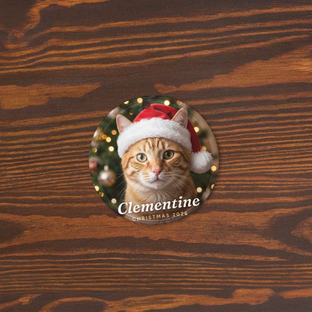 A by the tree pet ornament with a tabby cat, lying on a wooden table